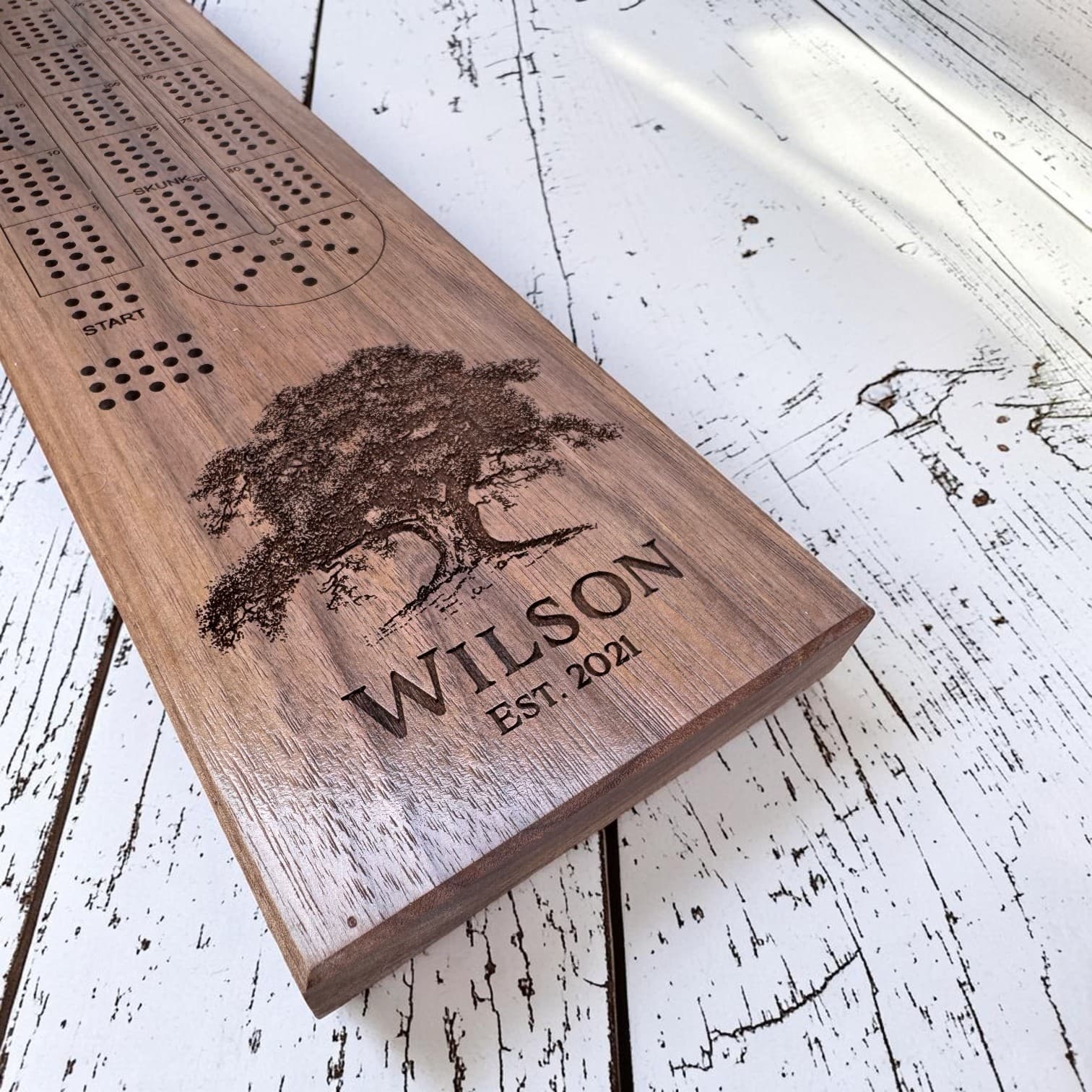 Your family name, your year, a hand-drawn tree — detail on the personalized cribbage board