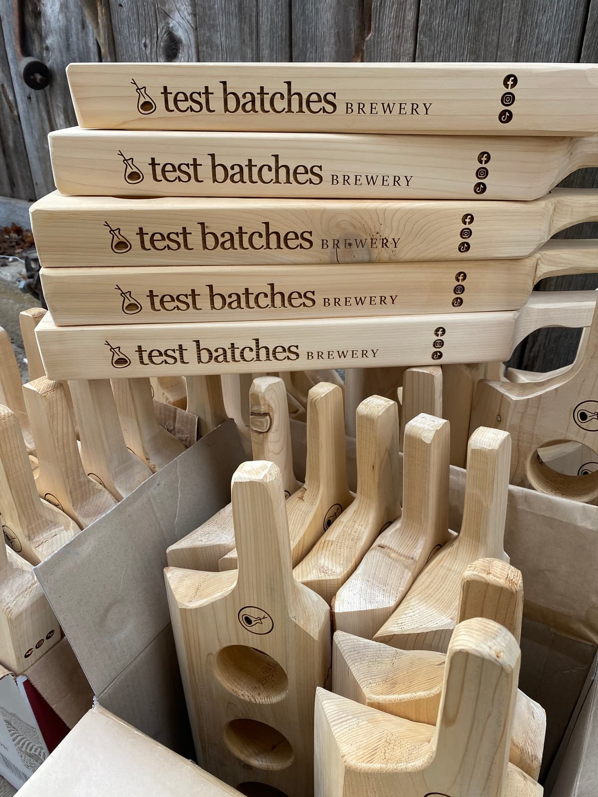 Handmade beer flight paddles with custom engraving before finishing