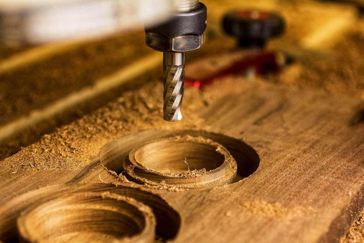 CNC-carved walnut ring boxes on the workbench