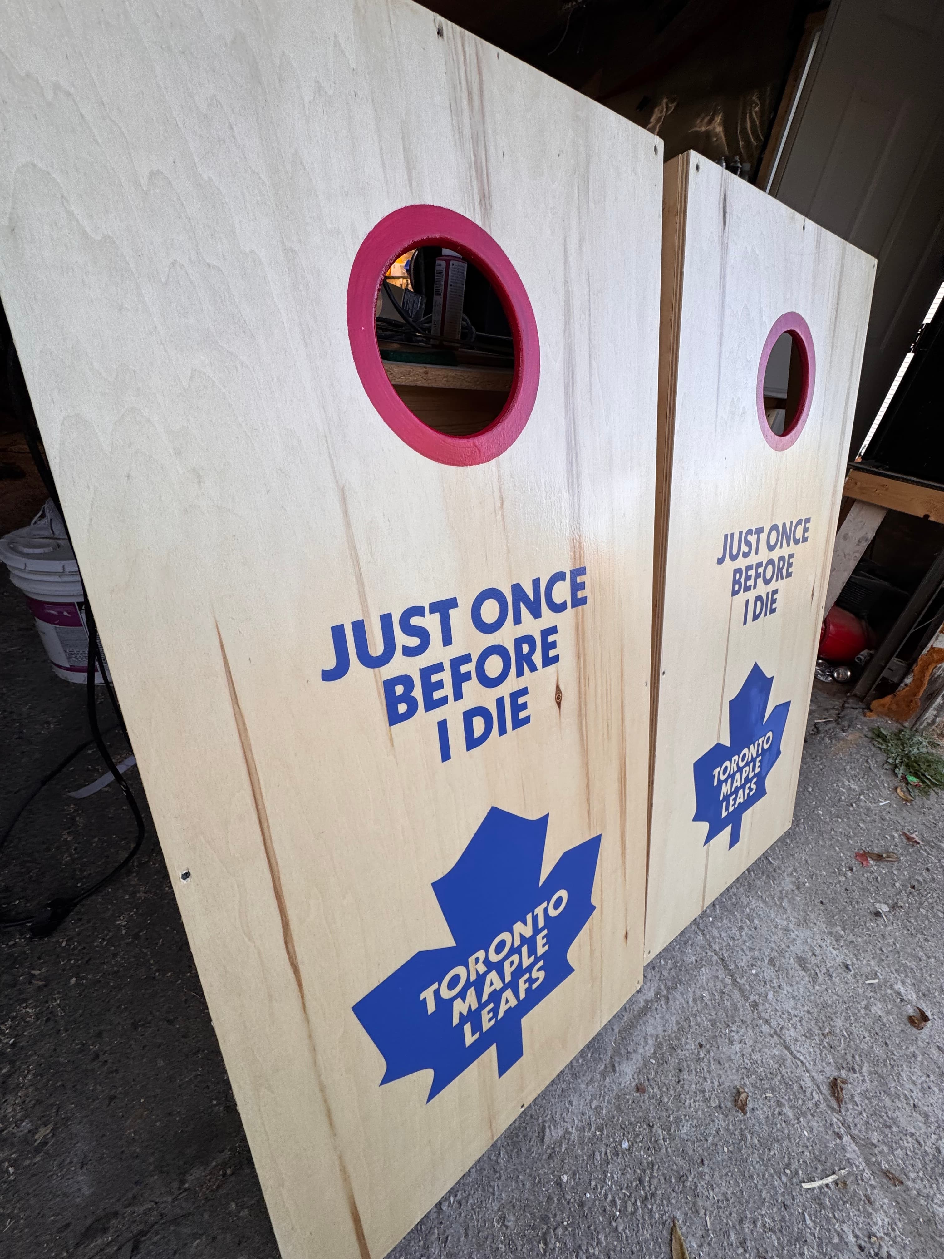 Two Maple Leafs cornhole boards laid flat showing the full surface with JUST ONCE BEFORE I DIE text and Toronto Maple Leafs logo in blue vinyl