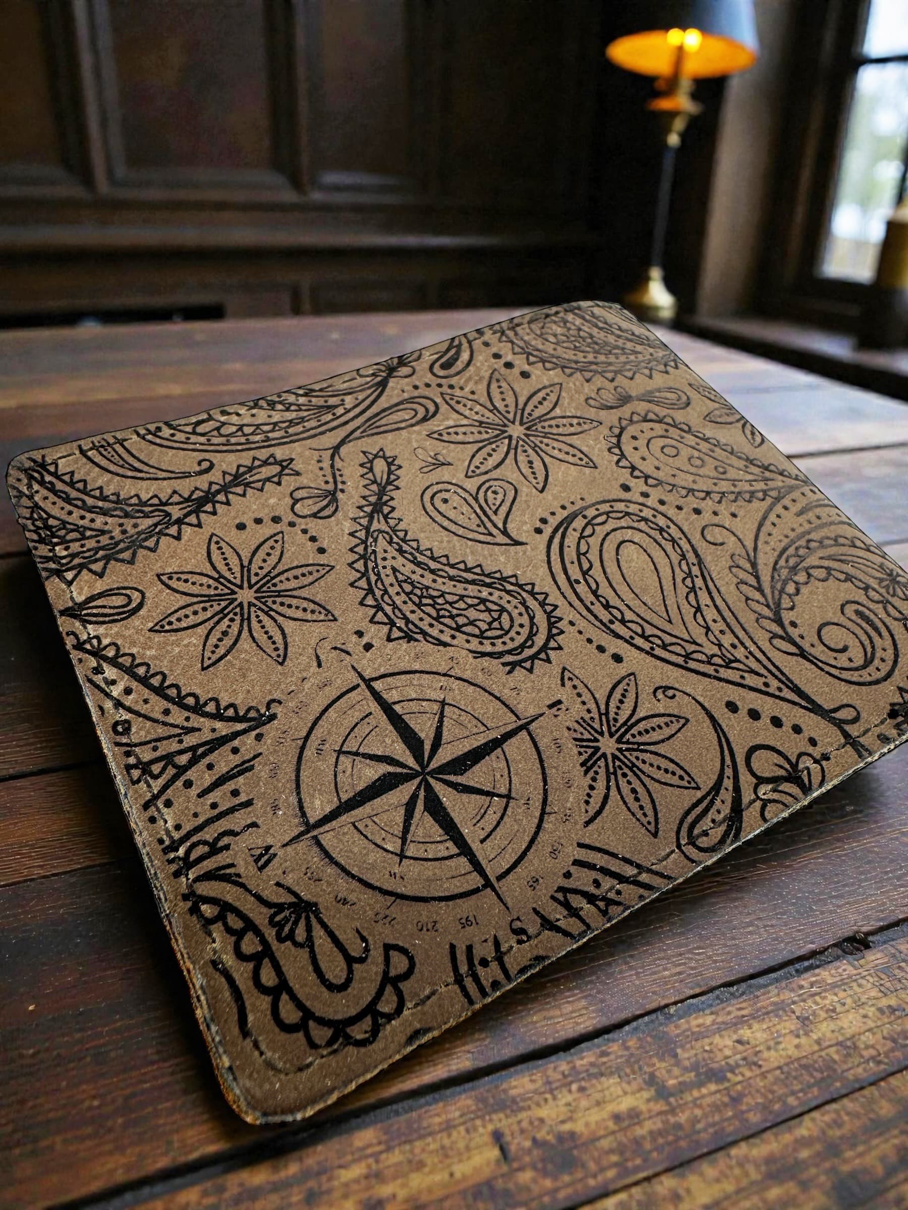 Reverse side of the wallet showing Paisley patterns surrounding a compass engraving
