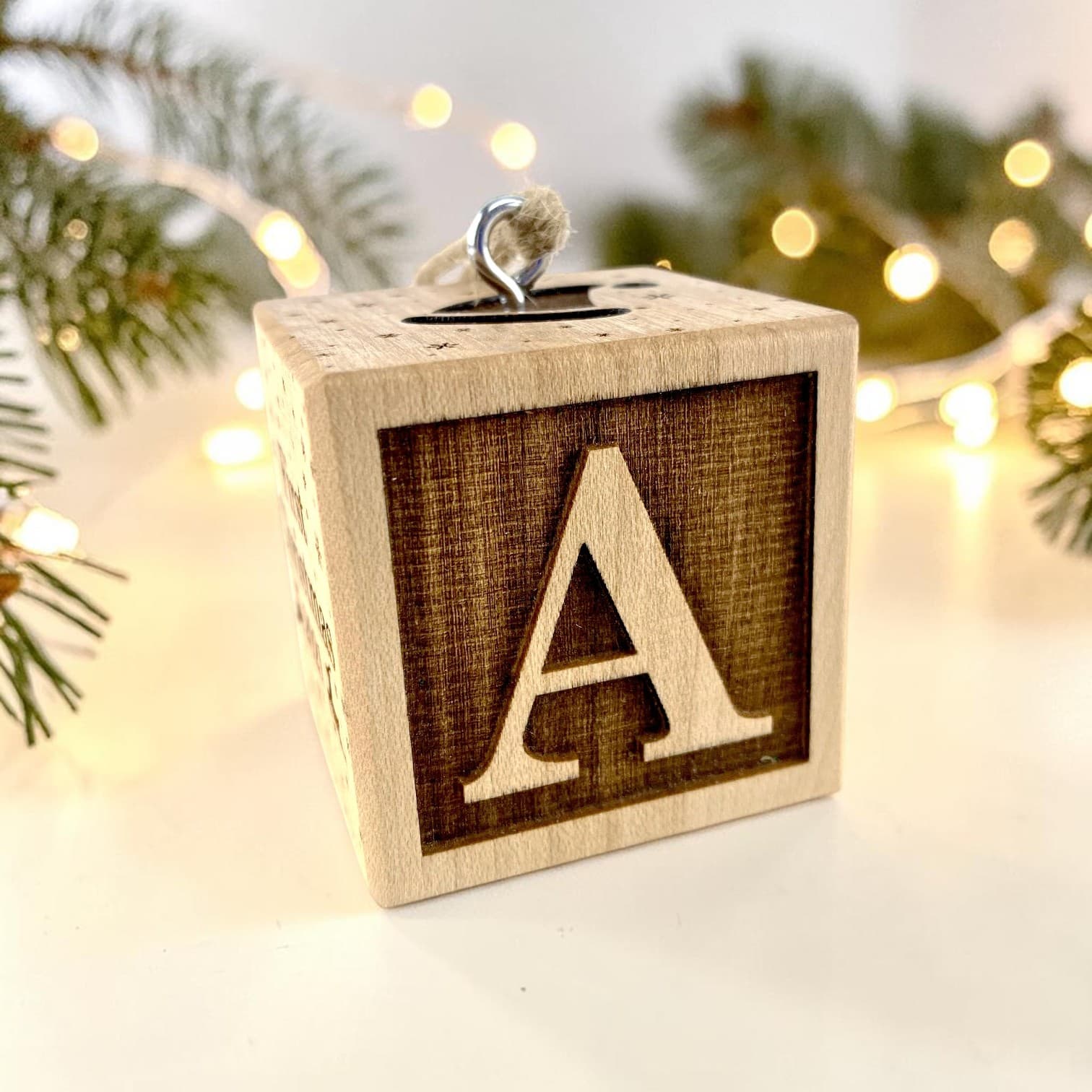 Their initial — engraved detail on the First Christmas Block