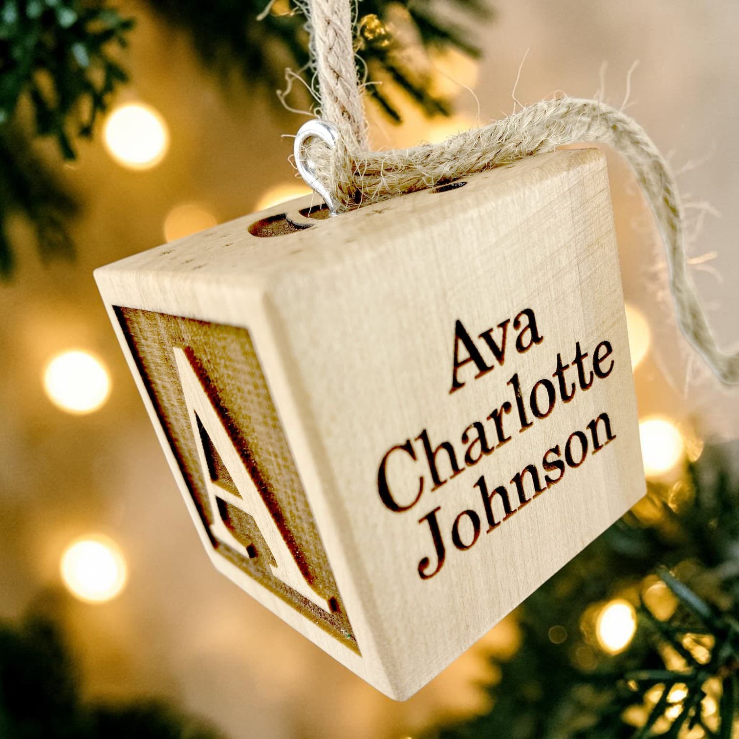 Their full name — engraved detail on the First Christmas Block