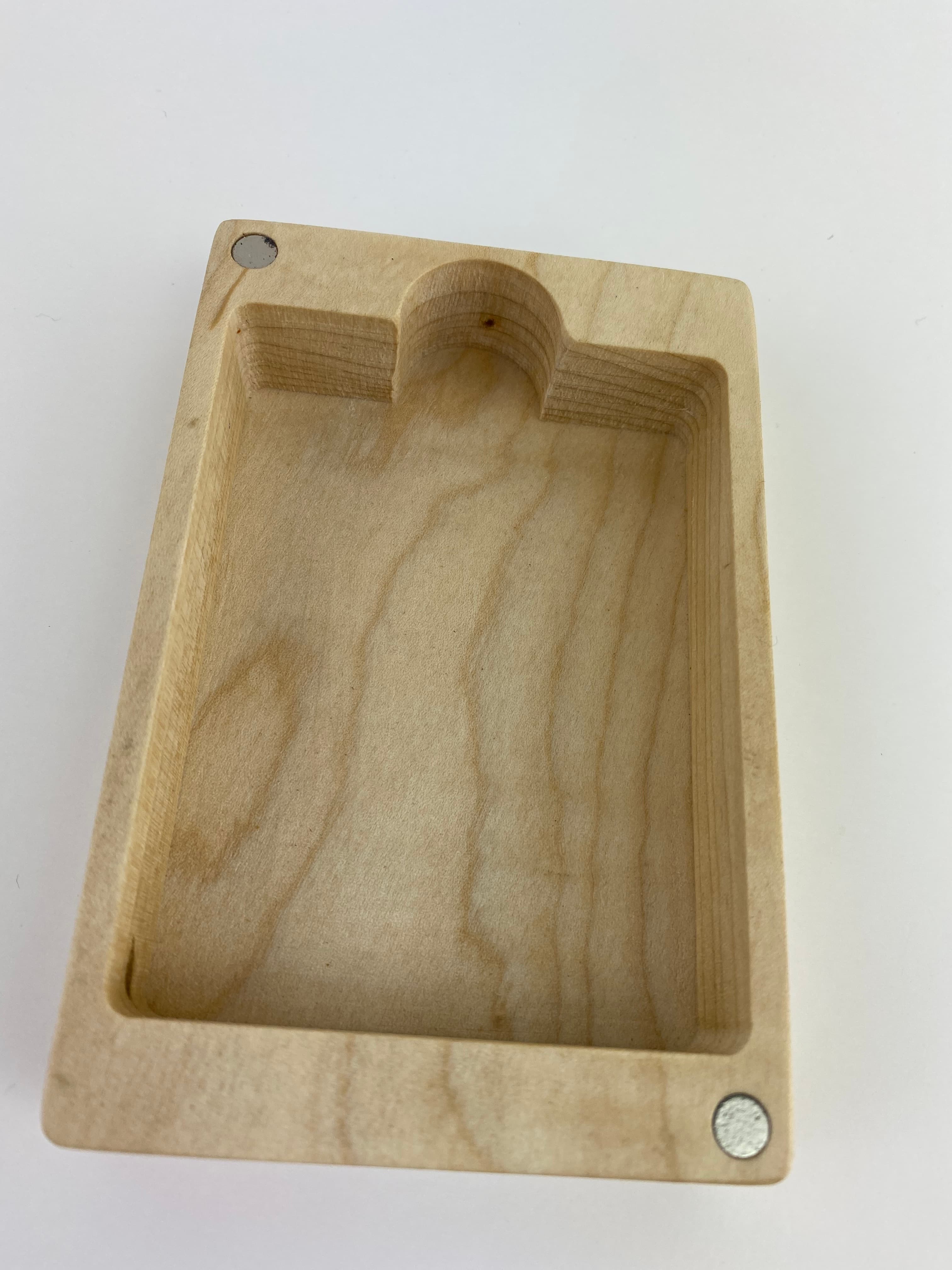 Interior of a finished playing card box showing the CNC-milled pocket, thumb notch, and neodymium magnets