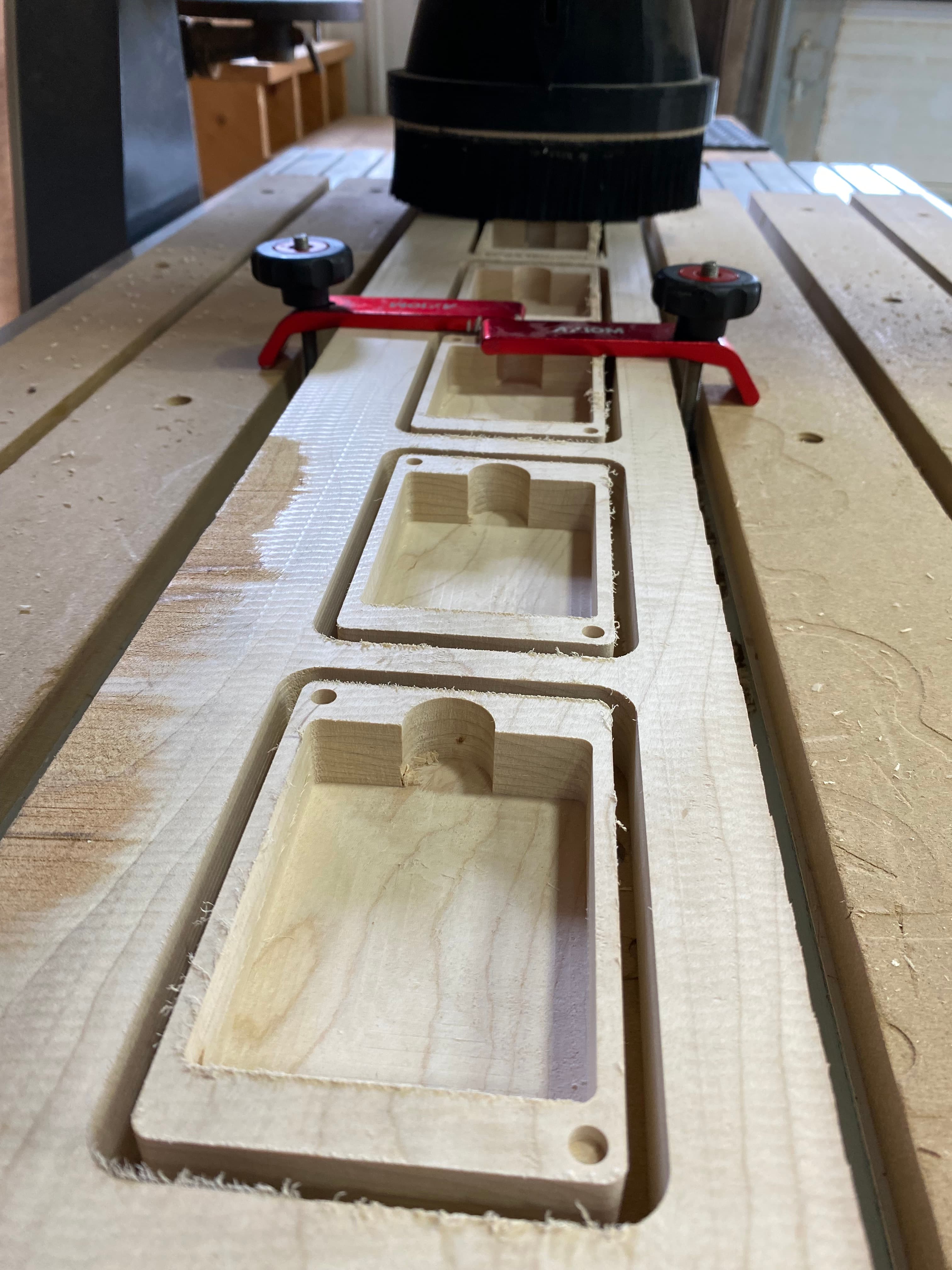 CNC machine pocketing multiple playing card box bodies from a maple board