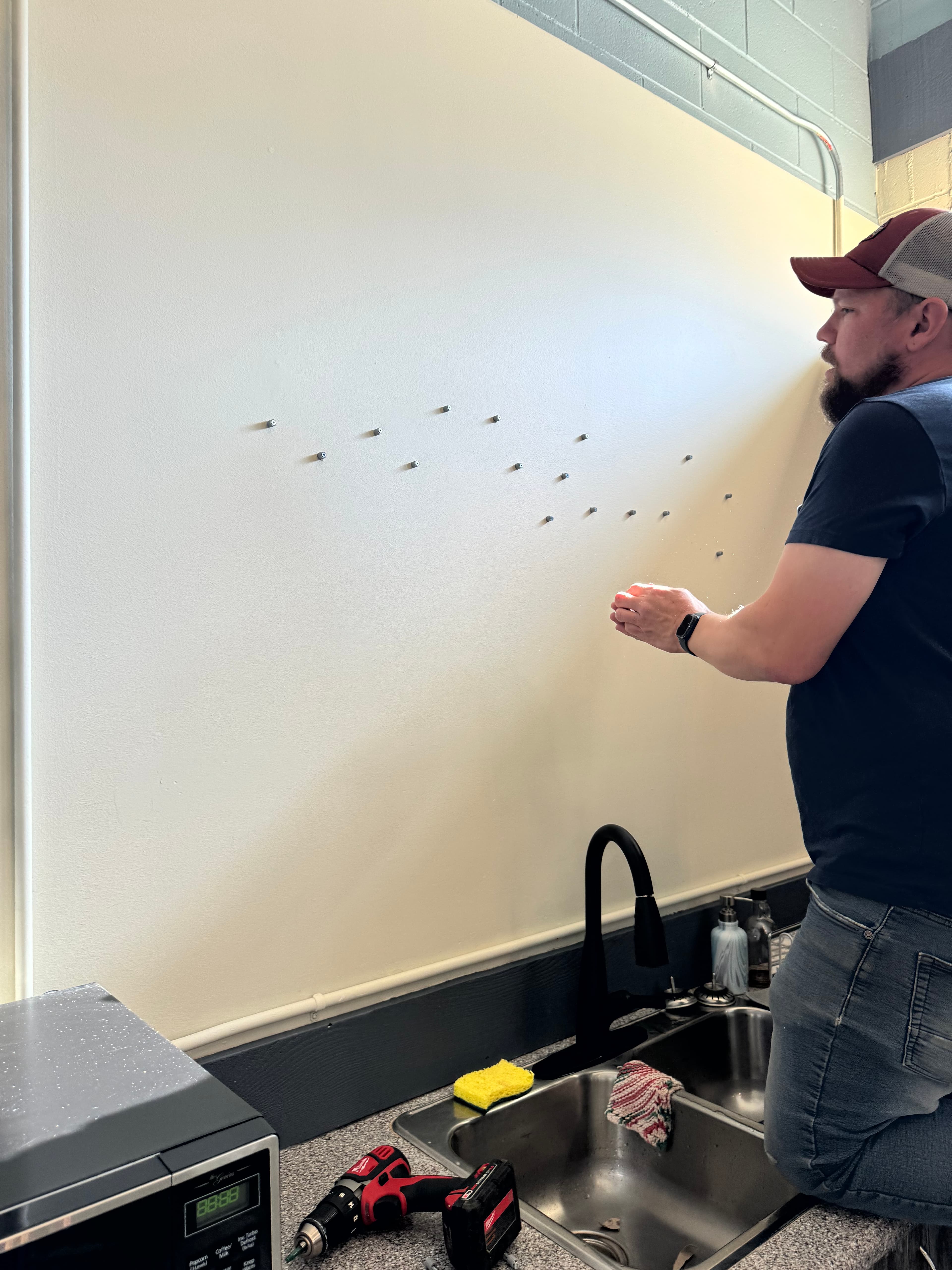 Installing standoff pegs into the wall using the plotter-generated template